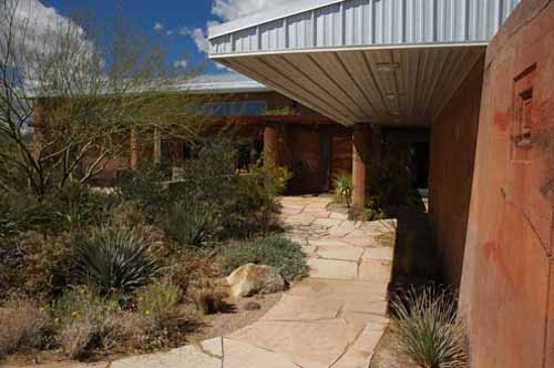 Native landscaping highlights the entry to a Poured Earth home in Phoenix, AZ